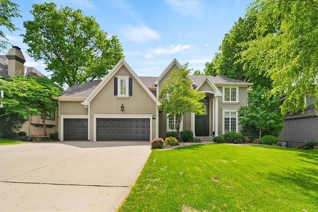 5817 W 147th Pl, Overland Park, KS 66223 - traditional-style home featuring stucco siding, driveway, a front lawn, and a garage