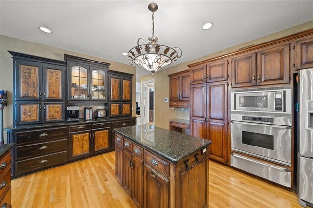 5817 W 147th Pl, Overland Park, KS 66223 - kitchen featuring appliances with stainless steel finishes, a warming drawer, a chandelier, light wood-type flooring, and recessed lighting