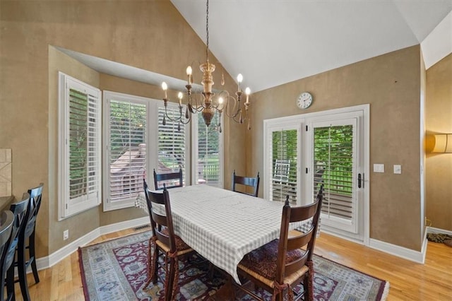 5817 W 147th Pl, Overland Park, KS 66223 - dining room featuring light wood-style floors, baseboards, high vaulted ceiling, and a chandelier