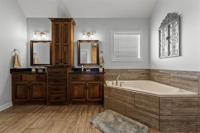 30307 Woodland Dr, Pleasant Hill, MO 64080 - bathroom featuring a garden tub, double vanity, and wood finished floors