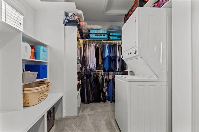 30307 Woodland Dr, Pleasant Hill, MO 64080 - laundry area featuring stacked washer and clothes dryer, light colored carpet, and attic access