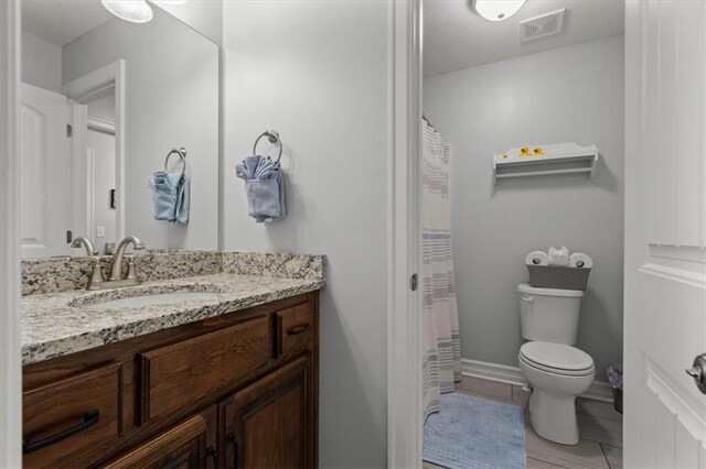 30307 Woodland Dr, Pleasant Hill, MO 64080 - bathroom featuring toilet, vanity, tile patterned flooring, and curtained shower
