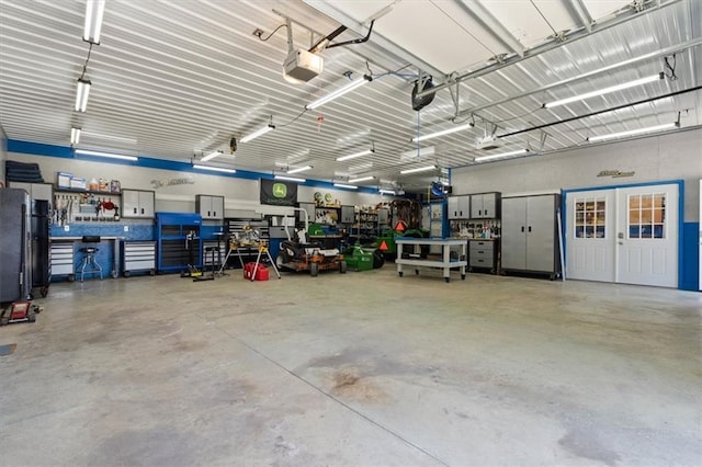 30307 Woodland Dr, Pleasant Hill, MO 64080 - garage with a garage door opener and a workshop area
