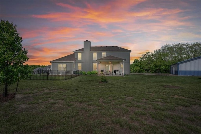 30307 Woodland Dr, Pleasant Hill, MO 64080 - back of house at dusk with a chimney and a patio area