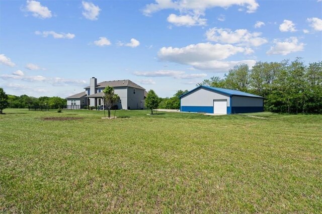 30307 Woodland Dr, Pleasant Hill, MO 64080 - view of grassy yard with a detached garage and an outdoor structure