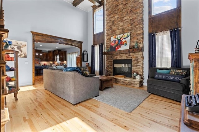 30307 Woodland Dr, Pleasant Hill, MO 64080 - living area featuring a towering ceiling, light wood finished floors, a fireplace, and beam ceiling