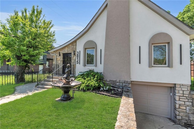 view of front of property with stucco siding, stone siding, and a garage