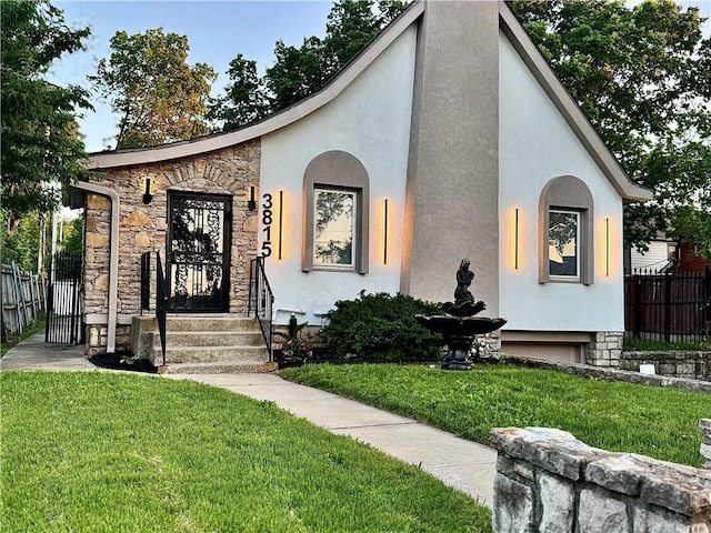 view of front of house with stucco siding and stone siding