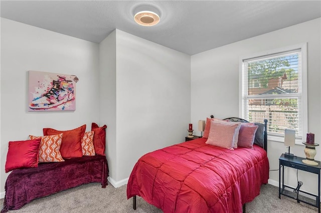 bedroom featuring carpet and baseboards