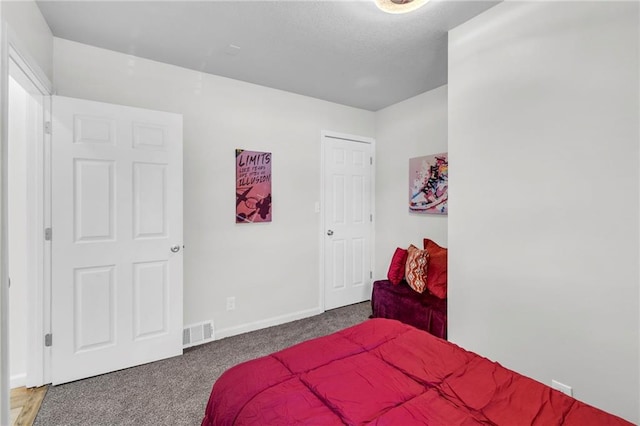 bedroom with carpet floors and baseboards