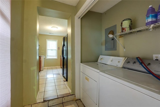 10101 E 18th St, Independence, MO 64052 - laundry area featuring electric panel, washer and dryer, light tile patterned floors, and baseboards