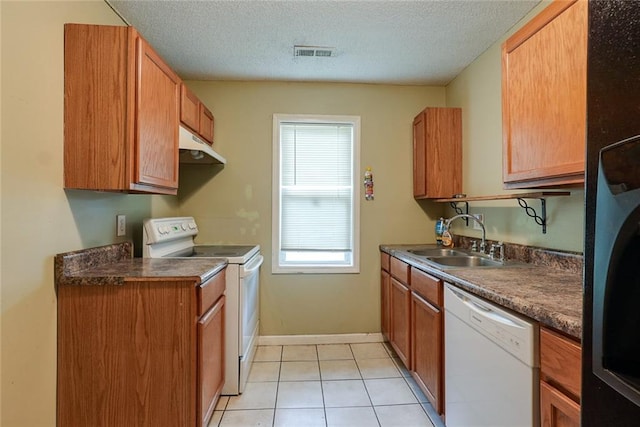 10101 E 18th St, Independence, MO 64052 - kitchen with white appliances, a sink, under cabinet range hood, a textured ceiling, and brown cabinets