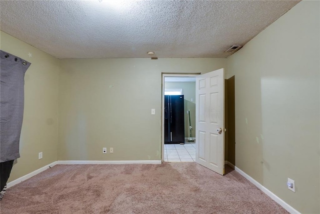 10101 E 18th St, Independence, MO 64052 - spare room with light colored carpet, a textured ceiling, and baseboards