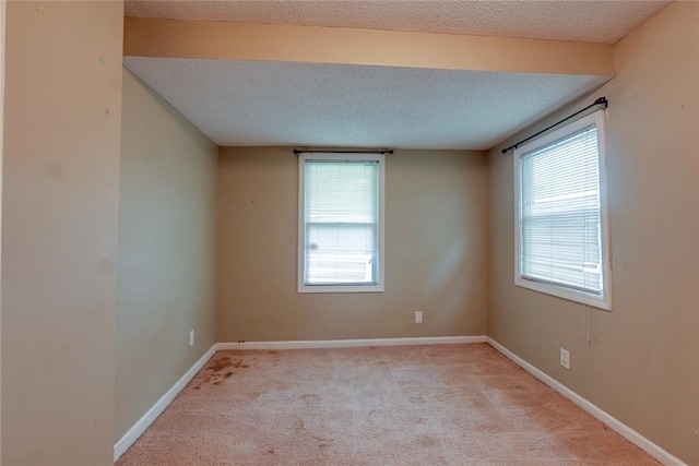 10101 E 18th St, Independence, MO 64052 - spare room with light colored carpet, baseboards, and a textured ceiling