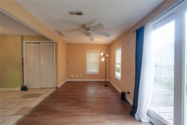 10101 E 18th St, Independence, MO 64052 - spare room with ceiling fan, light wood-style flooring, baseboards, and a textured ceiling