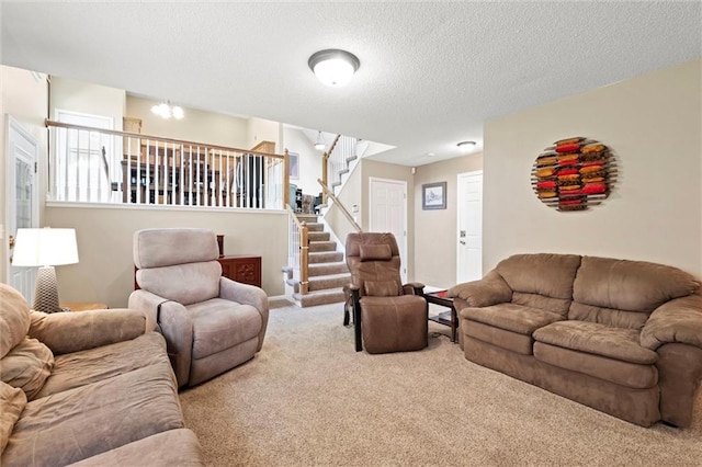 12434 England St, Overland Park, KS 66213 - carpeted living room featuring stairs and a textured ceiling