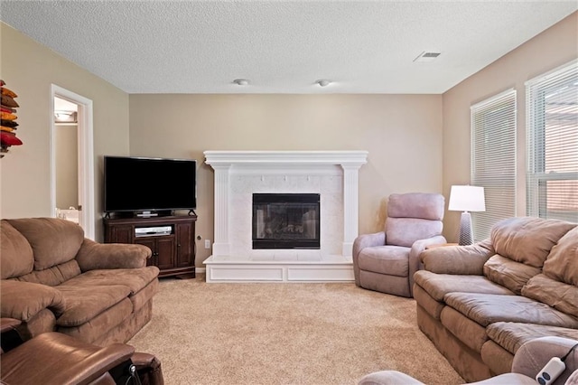 12434 England St, Overland Park, KS 66213 - living area with light colored carpet, a textured ceiling, and a fireplace