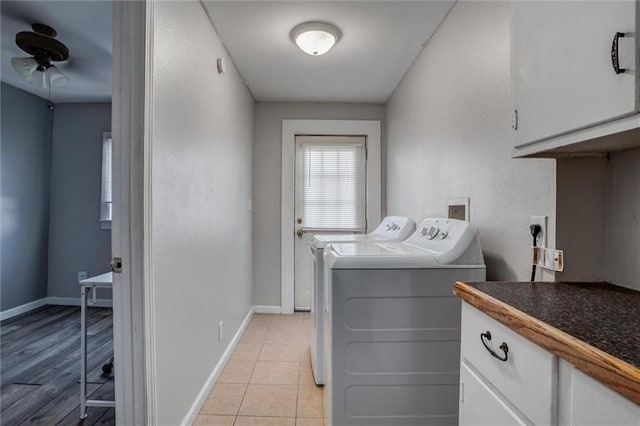 washroom with washing machine and dryer, cabinet space, ceiling fan, and baseboards
