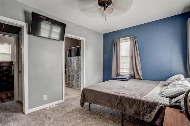 bedroom with multiple windows, carpet floors, baseboards, and ceiling fan