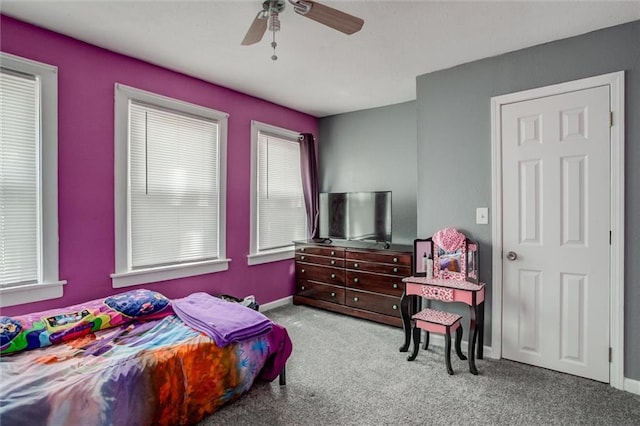 carpeted bedroom featuring a ceiling fan and baseboards