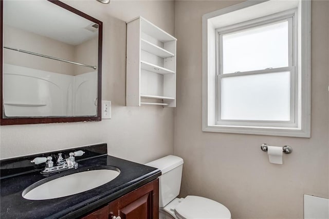 bathroom featuring toilet and vanity