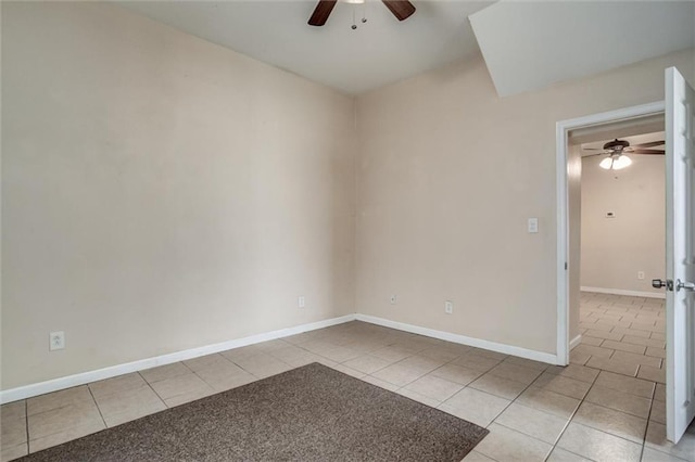 unfurnished room with ceiling fan, tile patterned flooring, and baseboards
