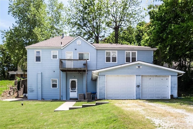 view of property featuring a balcony, driveway, and a front lawn