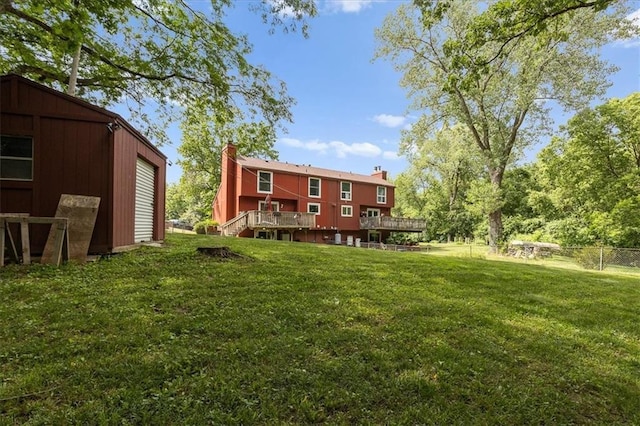 613 NE 90th Ter, Kansas City, MO 64155 - back of house featuring a chimney, a deck, and stairs