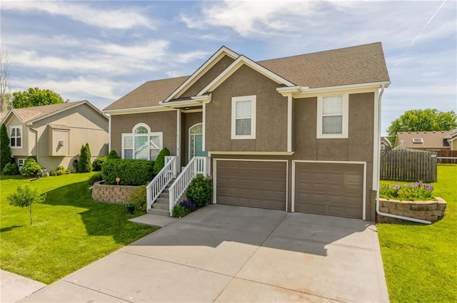 803 Crestridge Dr, Kearney, MO 64060 - raised ranch with an attached garage, driveway, a front lawn, and stucco siding