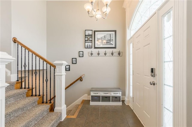803 Crestridge Dr, Kearney, MO 64060 - entrance foyer featuring a chandelier, dark tile patterned floors, and stairs