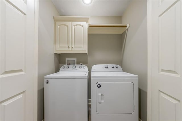 803 Crestridge Dr, Kearney, MO 64060 - laundry area with cabinet space and washer and clothes dryer