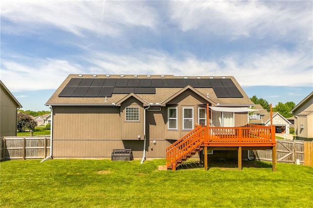 803 Crestridge Dr, Kearney, MO 64060 - rear view of property featuring a fenced backyard, a wooden deck, stairs, solar panels, and roof with shingles