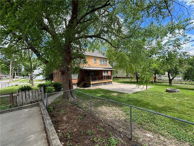 2702 Faraon St, Saint Joseph, MO 64501 - rear view of house with a fire pit and a patio area