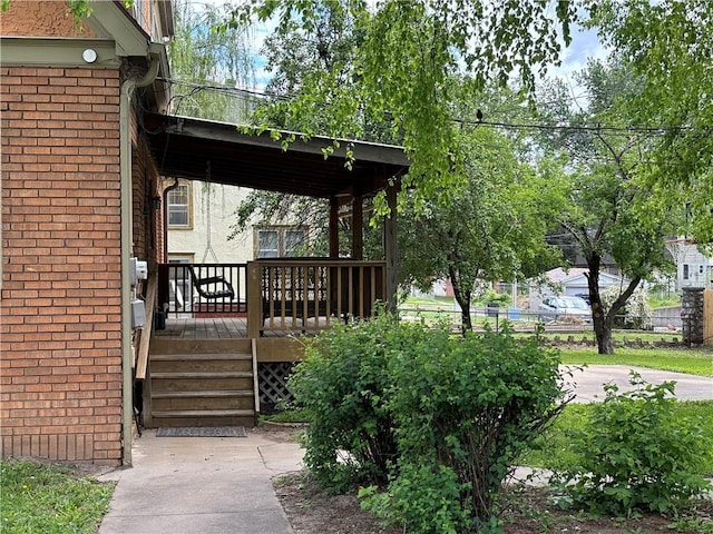 2702 Faraon St, Saint Joseph, MO 64501 - doorway to property with a wooden deck and brick siding