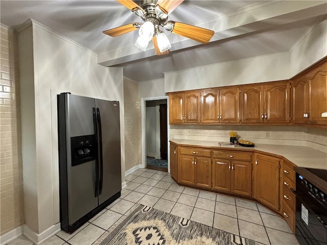2702 Faraon St, Saint Joseph, MO 64501 - kitchen with stainless steel refrigerator with ice dispenser, black range oven, brown cabinetry, ornamental molding, and light tile patterned floors