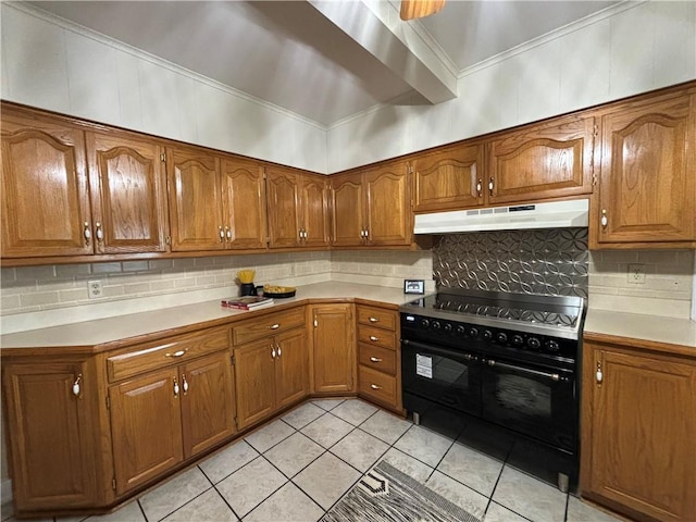 2702 Faraon St, Saint Joseph, MO 64501 - kitchen with under cabinet range hood, range with two ovens, brown cabinets, tasteful backsplash, and light countertops