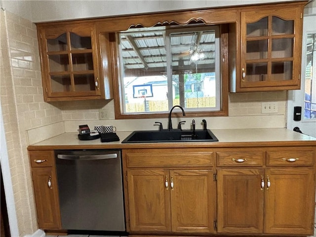 2702 Faraon St, Saint Joseph, MO 64501 - kitchen featuring stainless steel dishwasher, a sink, and brown cabinets