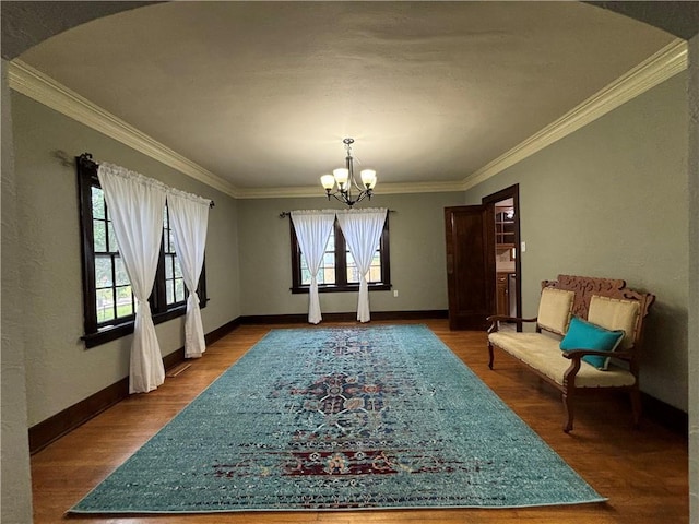 2702 Faraon St, Saint Joseph, MO 64501 - dining room featuring a chandelier, ornamental molding, wood finished floors, and baseboards