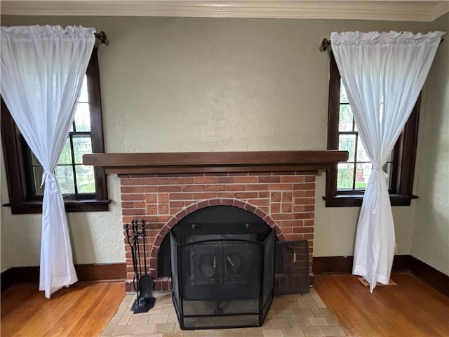 2702 Faraon St, Saint Joseph, MO 64501 - detailed view of a wood stove, ornamental molding, baseboards, and wood finished floors