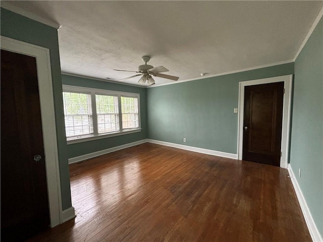 2702 Faraon St, Saint Joseph, MO 64501 - spare room with dark wood-style floors, ornamental molding, a ceiling fan, and baseboards