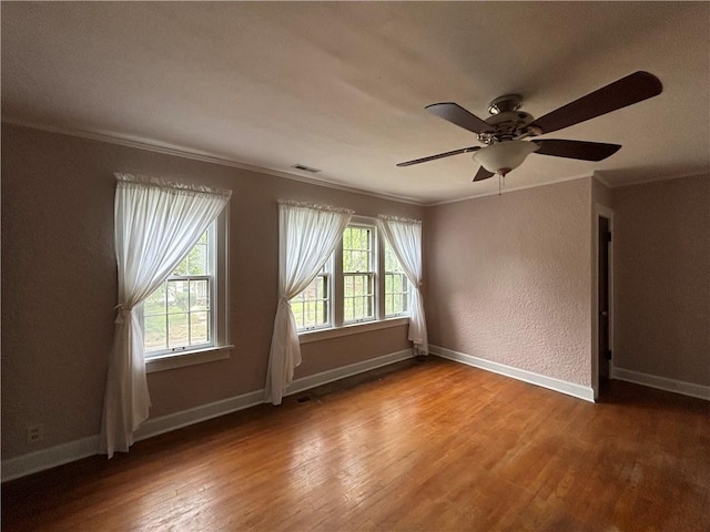 2702 Faraon St, Saint Joseph, MO 64501 - spare room with ornamental molding, wood finished floors, baseboards, ceiling fan, and a textured wall