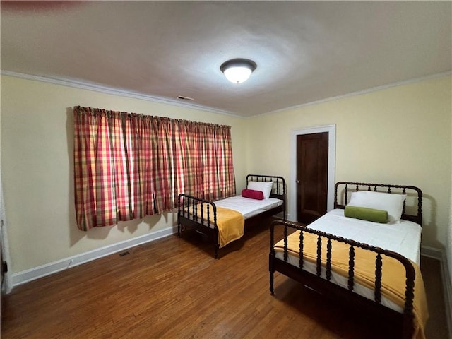 2702 Faraon St, Saint Joseph, MO 64501 - bedroom with ornamental molding, wood finished floors, and baseboards