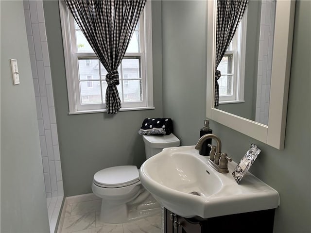 2702 Faraon St, Saint Joseph, MO 64501 - full bath featuring marble look tile flooring, toilet, a shower, baseboards, and vanity