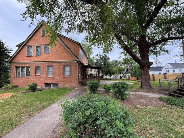 2702 Faraon St, Saint Joseph, MO 64501 - view of side of property with concrete driveway, brick siding, and covered porch
