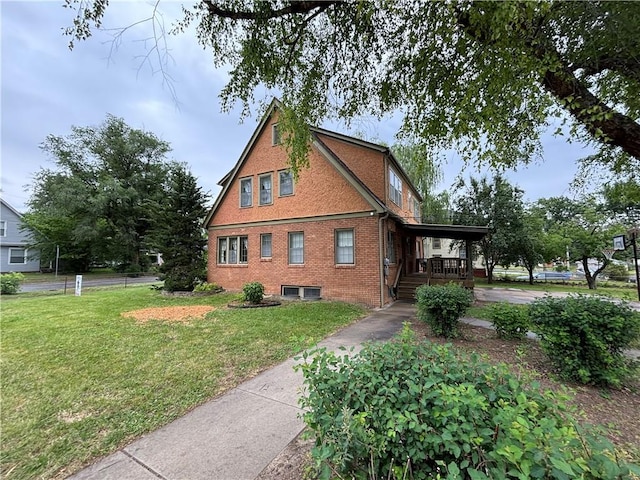 2702 Faraon St, Saint Joseph, MO 64501 - view of side of home with covered porch, a yard, brick siding, concrete driveway, and a carport