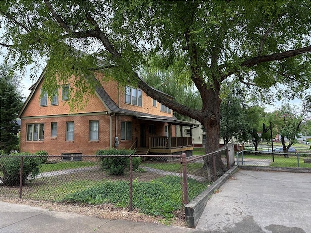 2702 Faraon St, Saint Joseph, MO 64501 - view of front of house with a fenced front yard, a porch, and brick siding