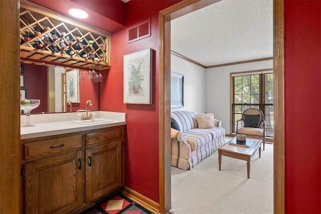 12224 Connell Dr, Overland Park, KS 66213 - bathroom featuring ornamental molding, vanity, and a textured ceiling