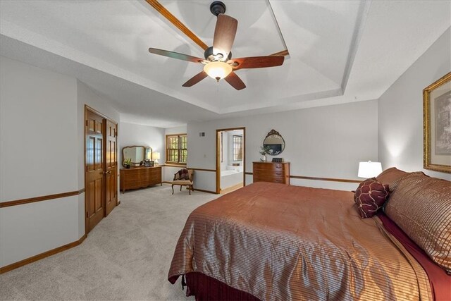12224 Connell Dr, Overland Park, KS 66213 - bedroom featuring a tray ceiling, light colored carpet, and ceiling fan