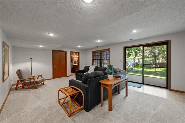 12224 Connell Dr, Overland Park, KS 66213 - living room with a textured ceiling, recessed lighting, light carpet, and light tile patterned floors