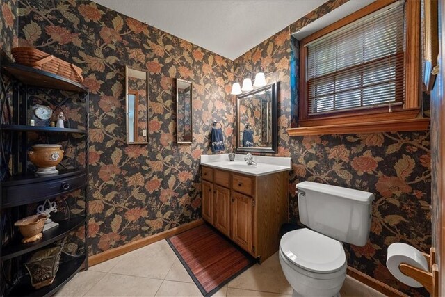12224 Connell Dr, Overland Park, KS 66213 - bathroom with vanity, tile patterned flooring, and wallpapered walls